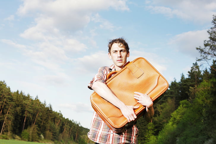 man with hugging luggage